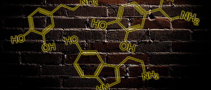 Several drug molecules pulse against a dark brick wall background